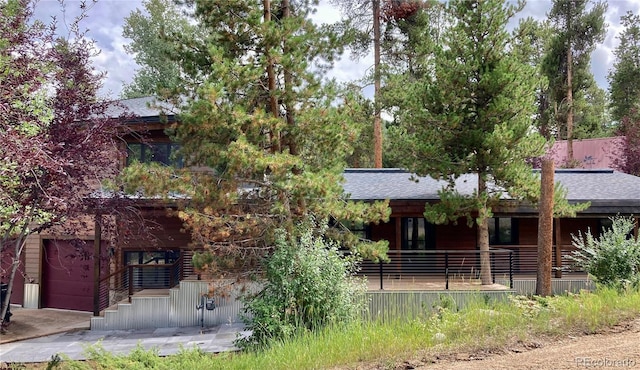 900 Tallaqua Dr, Grand Lake, CO 80447 - view of front of house featuring a porch, a shingled roof, and a garage