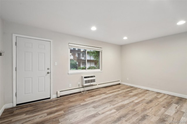 5875 E Iliff Ave Unit 108, Denver, CO 80222 - unfurnished room featuring light wood-type flooring, a baseboard radiator, recessed lighting, and baseboards
