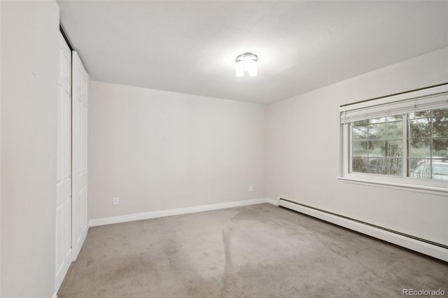 5875 E Iliff Ave Unit 108, Denver, CO 80222 - unfurnished bedroom with baseboard heating, carpet flooring, baseboards, and a closet