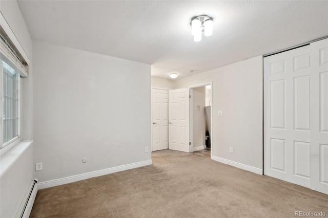 5875 E Iliff Ave Unit 108, Denver, CO 80222 - unfurnished bedroom with a baseboard radiator, light carpet, baseboards, and a closet