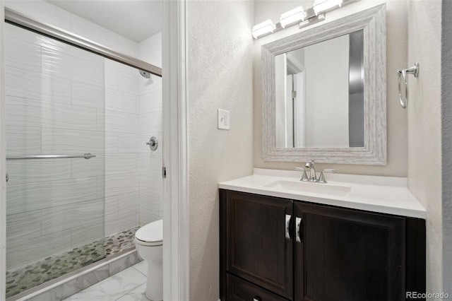 5875 E Iliff Ave Unit 108, Denver, CO 80222 - bathroom featuring toilet, a stall shower, marble finish flooring, vanity, and a textured wall