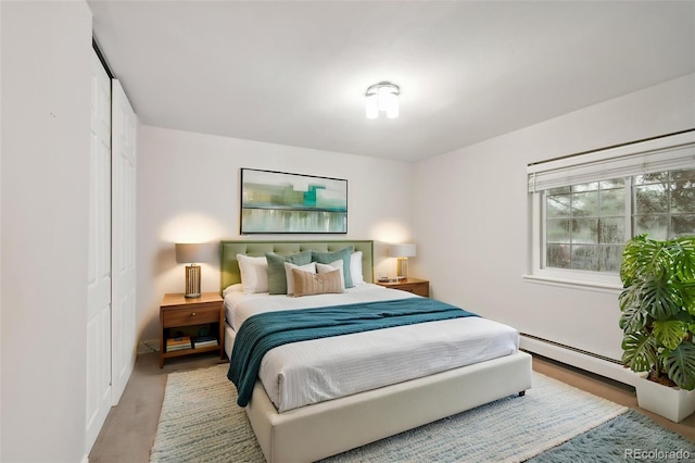 5875 E Iliff Ave Unit 108, Denver, CO 80222 - bedroom featuring a baseboard radiator and a closet