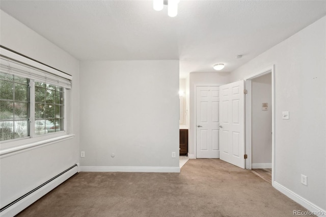 5875 E Iliff Ave Unit 108, Denver, CO 80222 - unfurnished bedroom with baseboard heating, carpet flooring, and baseboards