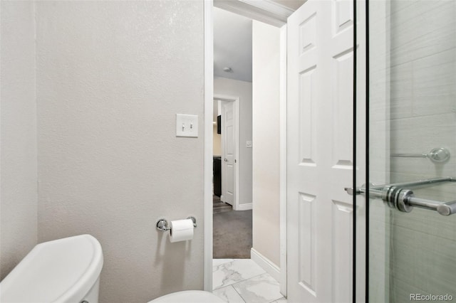 5875 E Iliff Ave Unit 108, Denver, CO 80222 - bathroom featuring toilet, marble finish flooring, and baseboards