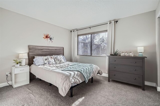 bedroom featuring baseboards and carpet flooring