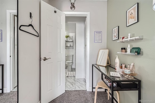 interior space with toilet and baseboards