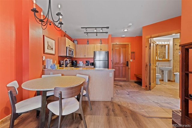 dining area with an inviting chandelier and light wood-style floors