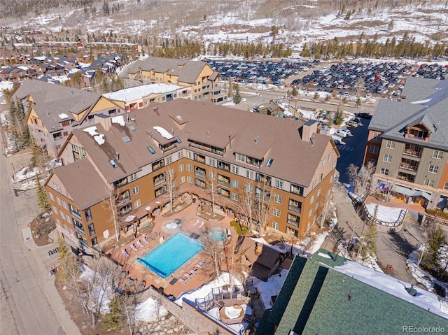 snowy aerial view with a residential view