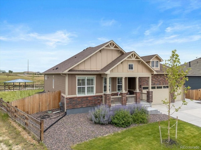 13476 Willow St, Thornton, CO 80602 - craftsman-style house with a porch, driveway, board and batten siding, brick siding, and a shingled roof