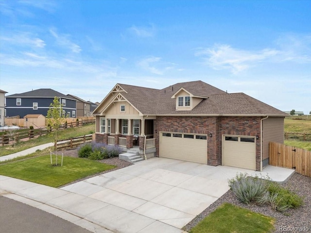 13476 Willow St, Thornton, CO 80602 - craftsman house with covered porch, concrete driveway, brick siding, an attached garage, and a shingled roof