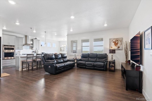 13476 Willow St, Thornton, CO 80602 - living room featuring dark wood-style floors, recessed lighting, and a chandelier