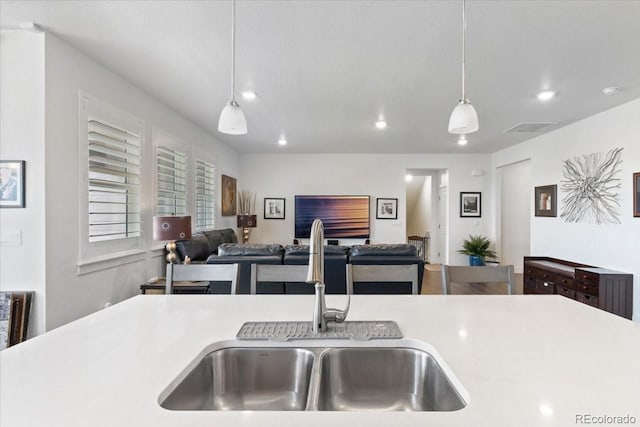 13476 Willow St, Thornton, CO 80602 - kitchen featuring decorative light fixtures, light countertops, recessed lighting, and open floor plan