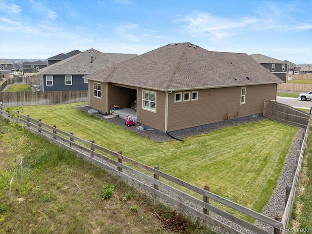 13476 Willow St, Thornton, CO 80602 - back of house featuring a fenced backyard, a patio area, a shingled roof, and a residential view