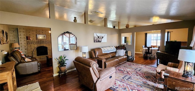 living room with dark wood-type flooring and vaulted ceiling