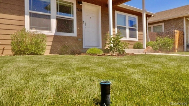 1503 Osage Ave, Fort Morgan, CO 80701 - view of exterior entry with a yard