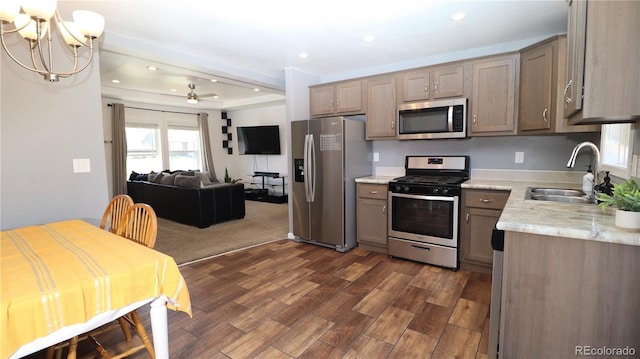 1503 Osage Ave, Fort Morgan, CO 80701 - kitchen featuring stainless steel appliances, a sink, dark wood-style floors, recessed lighting, and open floor plan