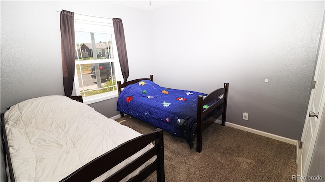 1503 Osage Ave, Fort Morgan, CO 80701 - bedroom featuring carpet floors, multiple windows, and baseboards