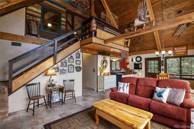 2169 Spruce Rd, Woodland Park, CO 80863 - living area with a wood ceiling with exposed beams, a chandelier, plenty of natural light, stone finish floors, and high vaulted ceiling