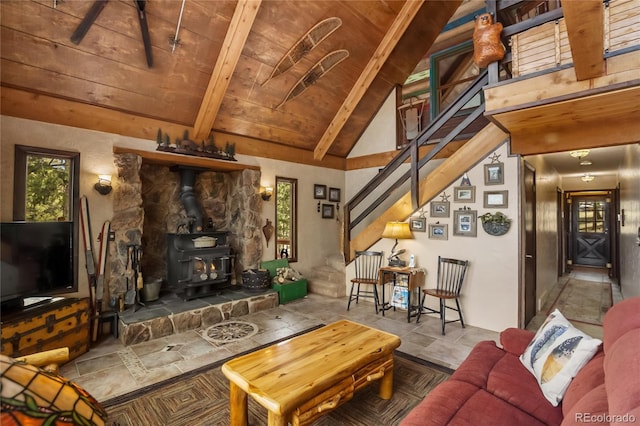 2169 Spruce Rd, Woodland Park, CO 80863 - living room with stairs, a wood stove, healthy amount of natural light, and wood ceiling