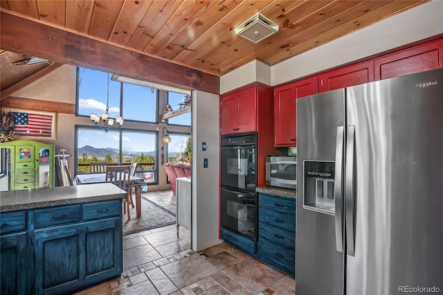 2169 Spruce Rd, Woodland Park, CO 80863 - kitchen with stainless steel appliances, wood ceiling, a chandelier, dark countertops, and stone tile flooring