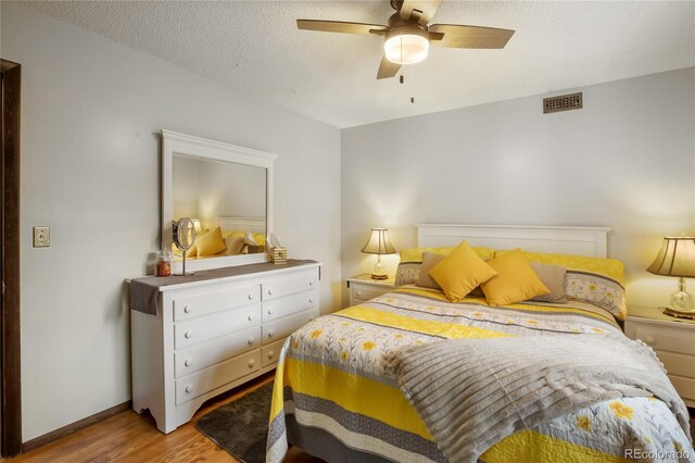2169 Spruce Rd, Woodland Park, CO 80863 - bedroom featuring light wood-style floors, a ceiling fan, and a textured ceiling
