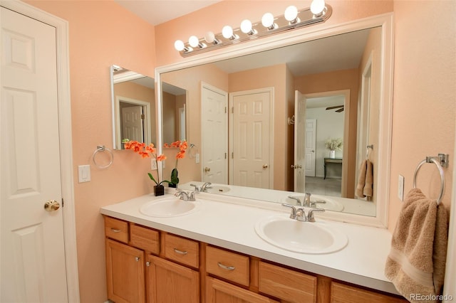 bathroom with a sink and double vanity