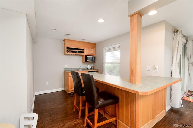 bar featuring recessed lighting, dark wood-style floors, wet bar, visible vents, and stainless steel microwave