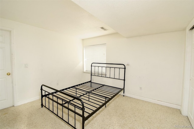 bedroom featuring baseboards and visible vents