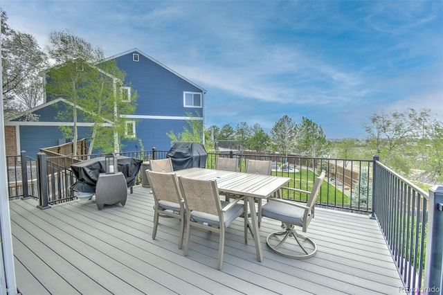 deck featuring outdoor dining space and a grill