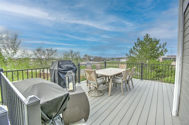 wooden deck featuring grilling area and outdoor dining space