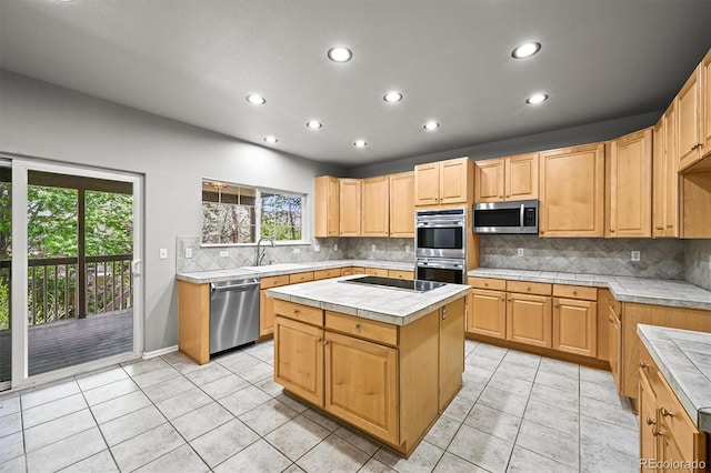 2732 Flint Ct, Superior, CO 80027 - kitchen with appliances with stainless steel finishes, tile counters, recessed lighting, a center island, and light tile patterned floors