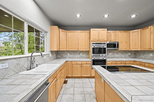 2732 Flint Ct, Superior, CO 80027 - kitchen with tile counters, appliances with stainless steel finishes, a sink, light brown cabinets, and recessed lighting