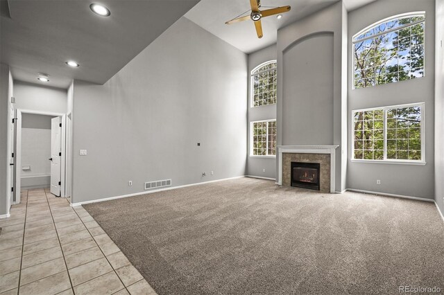 2732 Flint Ct, Superior, CO 80027 - unfurnished living room with a ceiling fan, a high ceiling, baseboards, recessed lighting, and light carpet