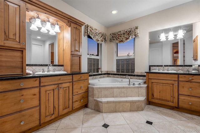 bathroom with tasteful backsplash, tile flooring, double sink, large vanity, and tiled tub