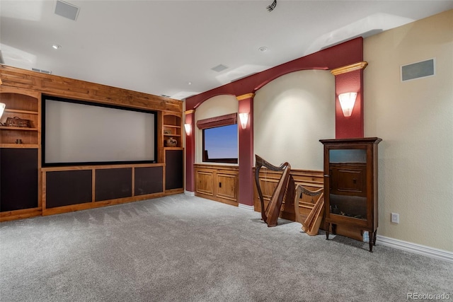 home theater with built in features and carpet flooring