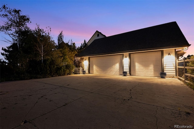 view of garage at dusk