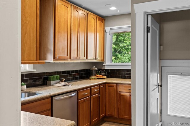 2271 Holly St, Denver, CO 80207 - kitchen with dishwasher, decorative backsplash, and brown cabinetry
