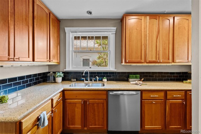 2271 Holly St, Denver, CO 80207 - kitchen with stainless steel dishwasher, a sink, tasteful backsplash, light stone countertops, and brown cabinets