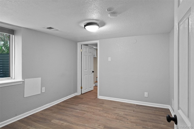 2271 Holly St, Denver, CO 80207 - unfurnished bedroom with dark wood finished floors, a textured ceiling, and baseboards