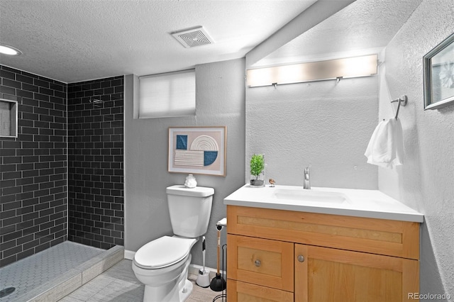 2271 Holly St, Denver, CO 80207 - full bath featuring a textured ceiling, toilet, vanity, a tile shower, and a textured wall