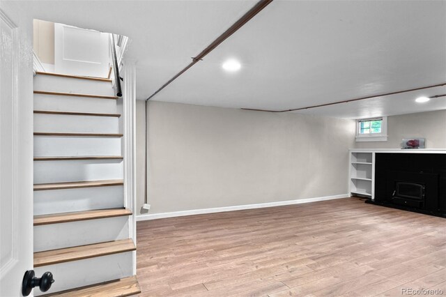 2271 Holly St, Denver, CO 80207 - basement with light wood-type flooring, baseboards, stairs, and recessed lighting