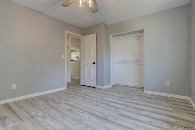 unfurnished bedroom featuring ceiling fan, light hardwood / wood-style floors, and a closet