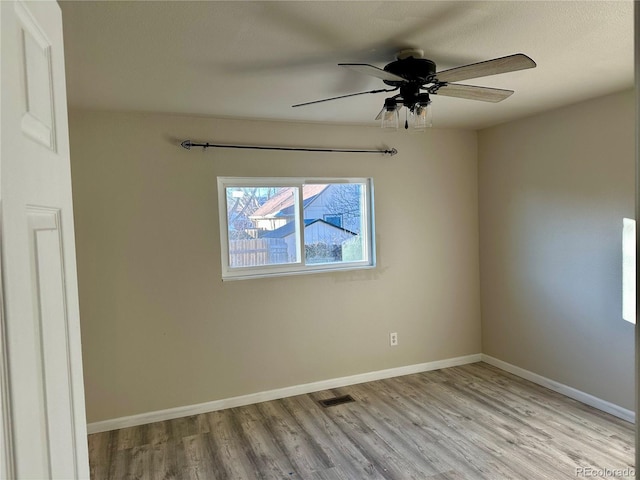 empty room featuring ceiling fan and light hardwood / wood-style flooring