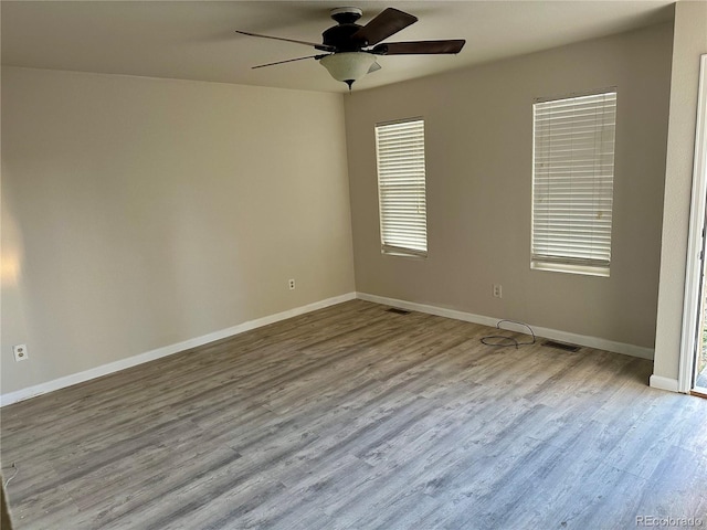 unfurnished room with ceiling fan and light wood-type flooring