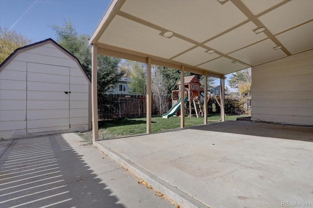 view of patio / terrace with a playground and a shed