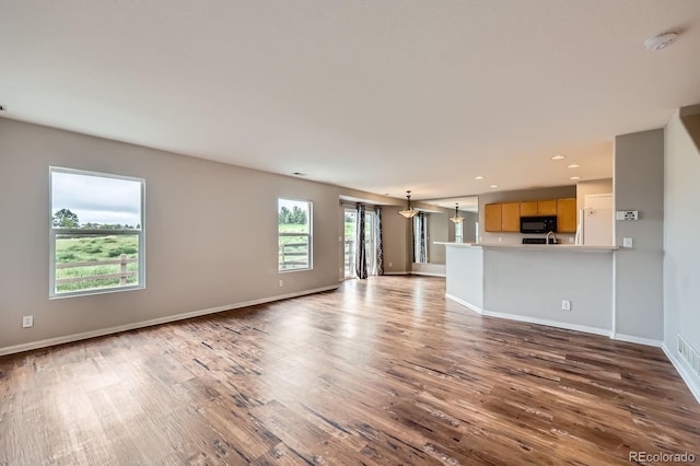 5653 Raleigh Cir, Castle Rock, CO 80104 - unfurnished living room featuring wood finished floors, baseboards, and recessed lighting