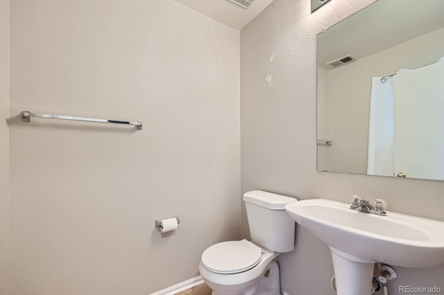 5653 Raleigh Cir, Castle Rock, CO 80104 - half bathroom featuring toilet, a sink, and baseboards
