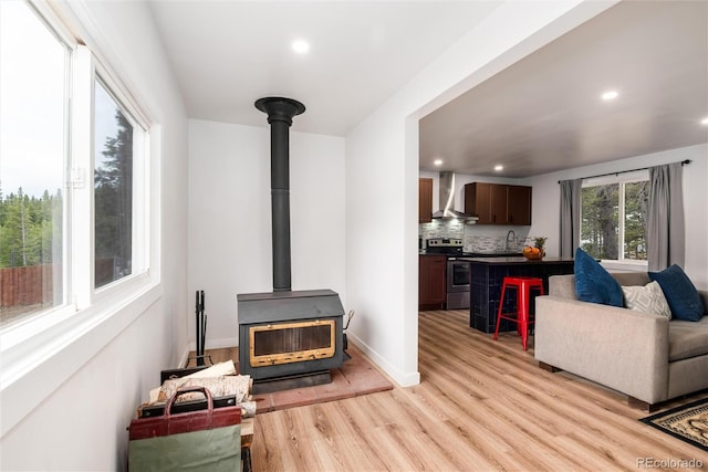 192 Little Creek Rd, Idaho Springs, CO 80452 - living area with a wood stove, light wood-style floors, recessed lighting, and baseboards