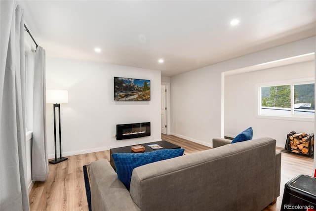 192 Little Creek Rd, Idaho Springs, CO 80452 - living room with light wood-style flooring, a glass covered fireplace, recessed lighting, and baseboards