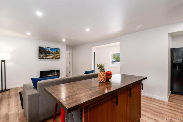 192 Little Creek Rd, Idaho Springs, CO 80452 - dining space with light wood finished floors, a glass covered fireplace, recessed lighting, and baseboards